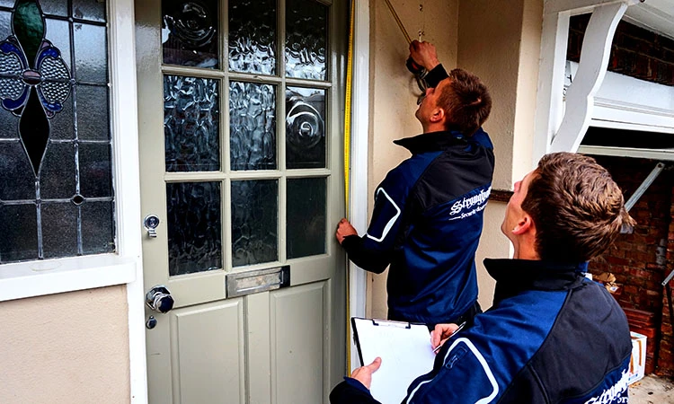 Our team working out a quote for a security door in London.